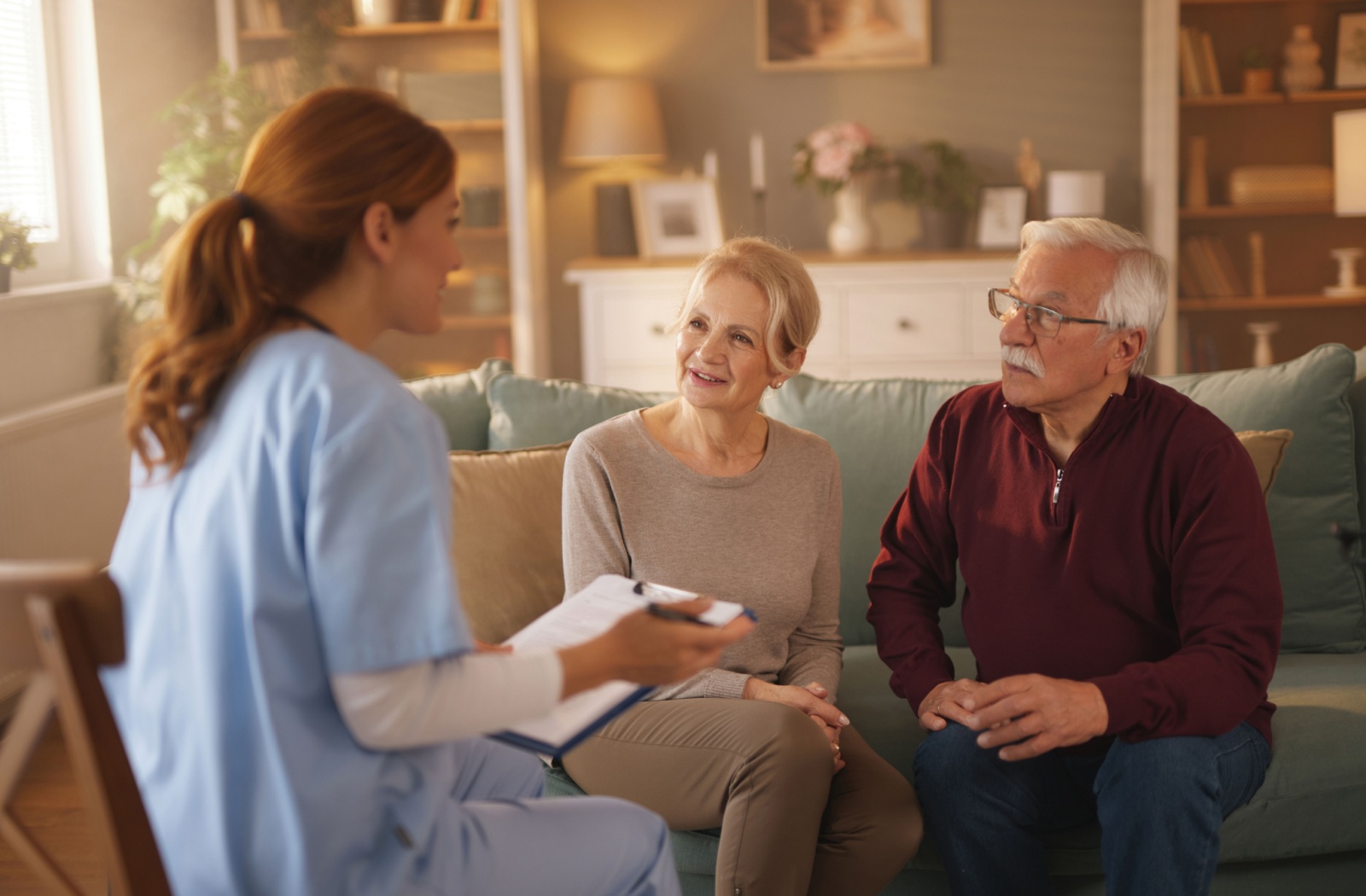 A senior couple talk to a staff member at a senior living community while on a tour to learn about what life is like there