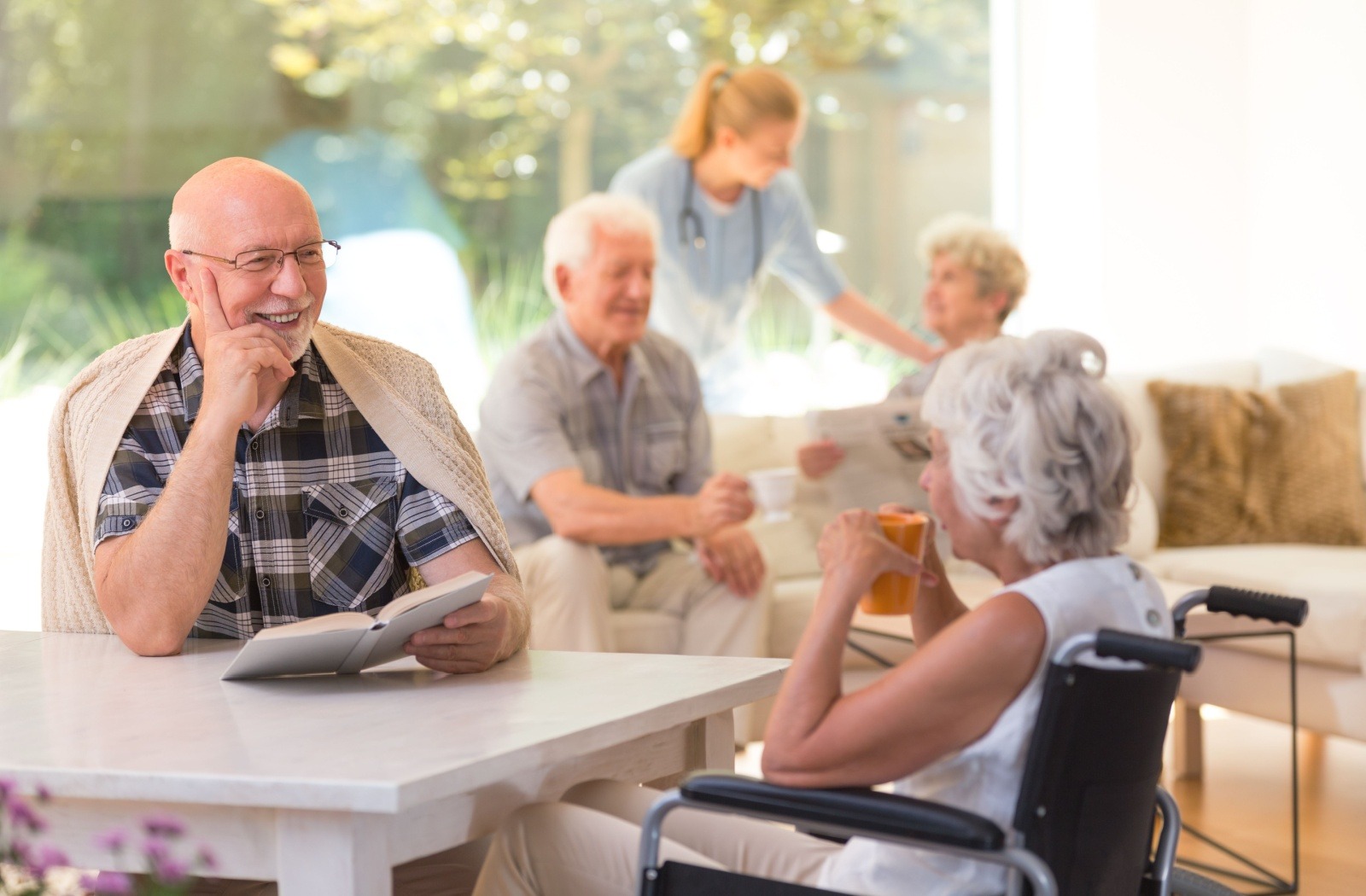 A group of senior friends socialize in a senior living community.
